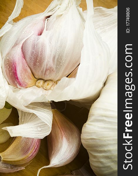 Marketfresh organic garlic cloves on a wooden table surface