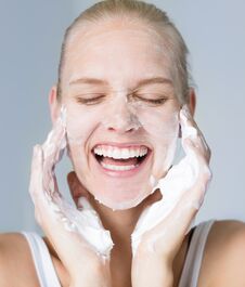 Pretty Woman Cleansing Her Face With Water And Soap. Beauty And Skincare Stock Images