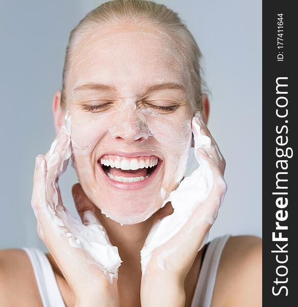 Pretty Woman Cleansing Her Face With Water And Soap. Beauty And Skincare