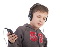 The Boy Listens To Music Stock Image