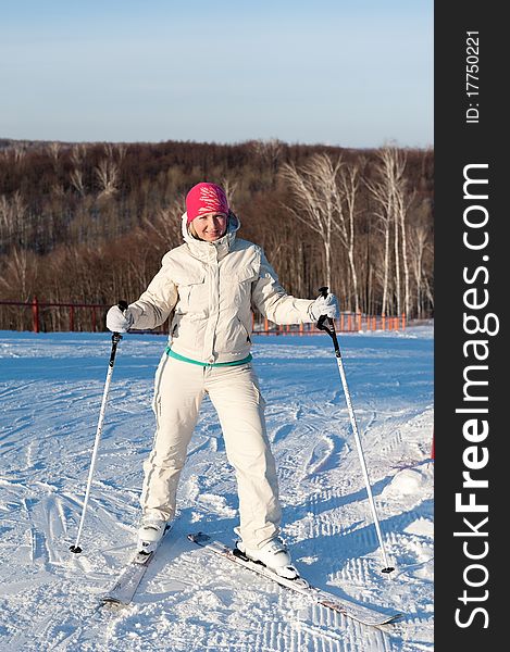 The skier girl standing on a snowly slope. Winter. The skier girl standing on a snowly slope. Winter