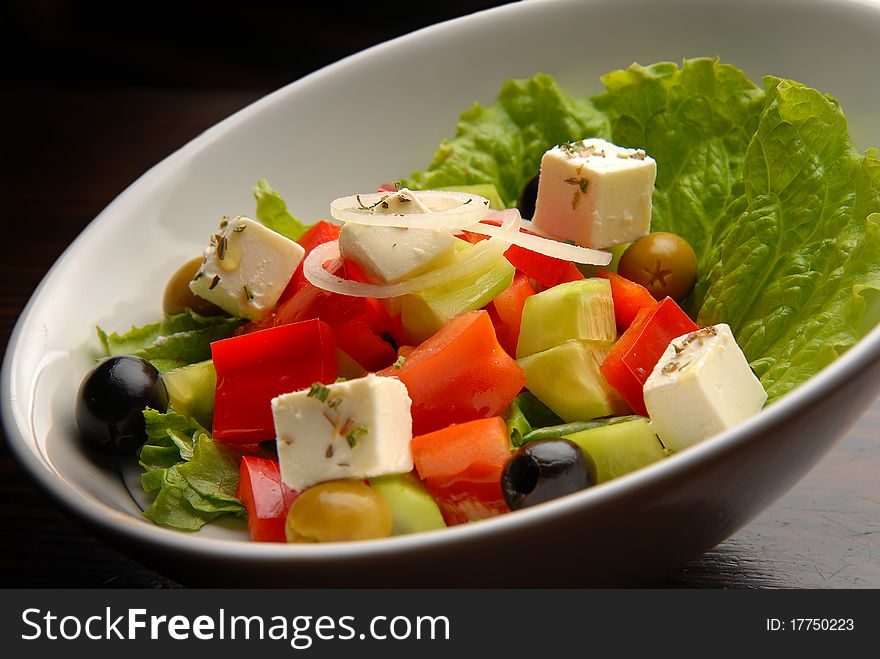 Vegetable fresh salad with a paprika cheese olives and cucumbers. Vegetable fresh salad with a paprika cheese olives and cucumbers