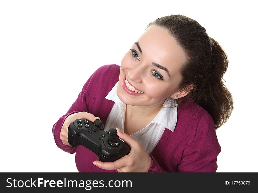 Young women play wideogame by gamepad on the white isolated background. Young women play wideogame by gamepad on the white isolated background