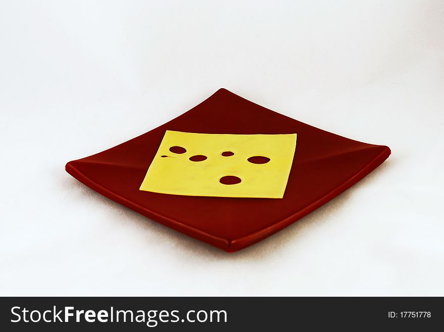 A slice of cheese on brown plate