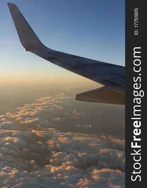 The view out a window of an airplane on a business trip at sunrise. The view out a window of an airplane on a business trip at sunrise