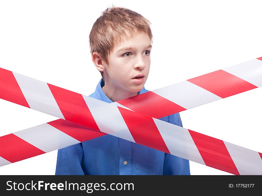 Boy behind cordon tape, isolated on white