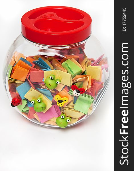 colorful messages in a glass jar isolated in white