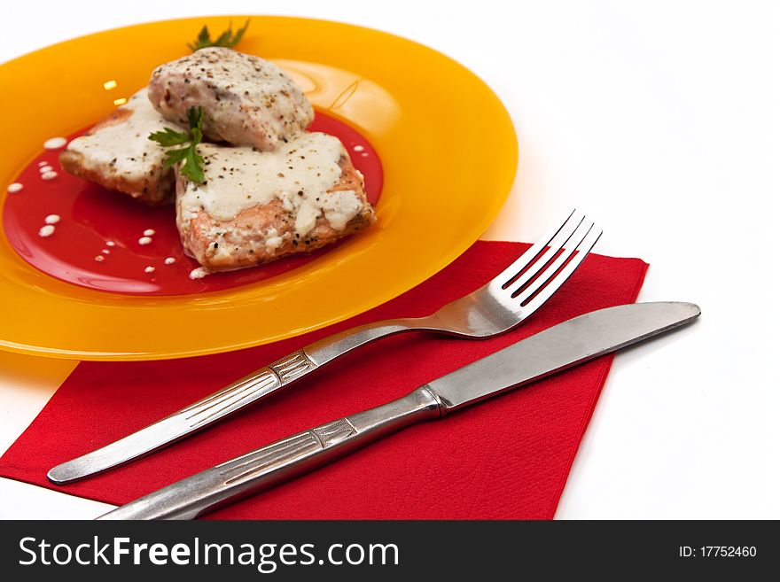 Grilled salmon with cream sauce and parsley isolated in white