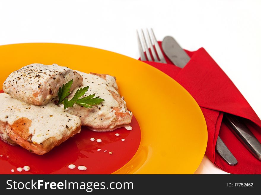 Grilled salmon with cream sauce and parsley isolated in white