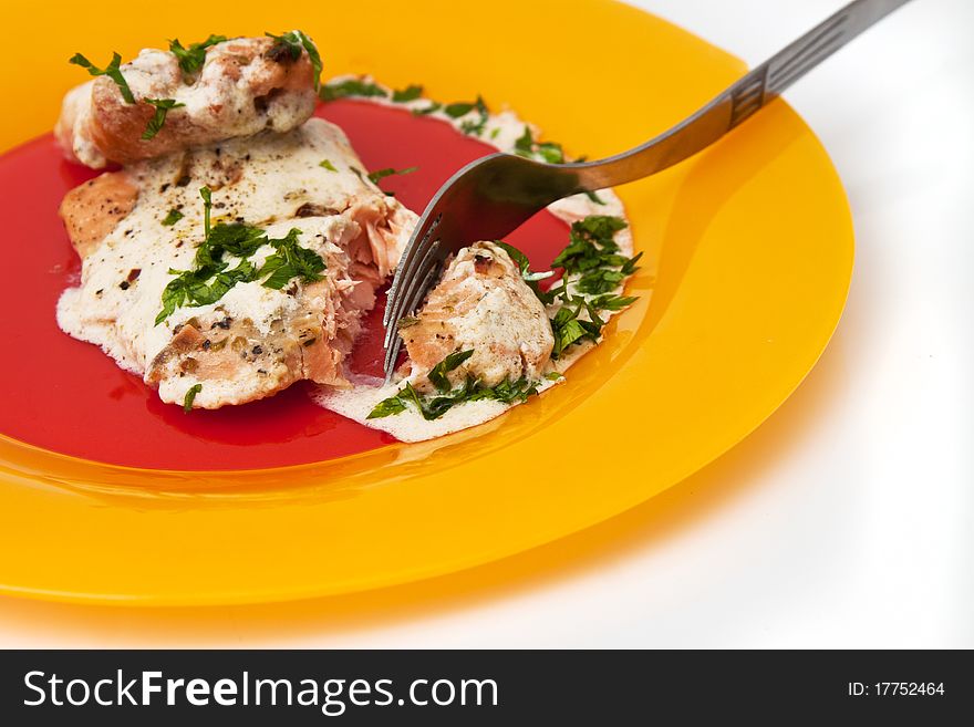 Grilled salmon with cream sauce and parsley isolated in white