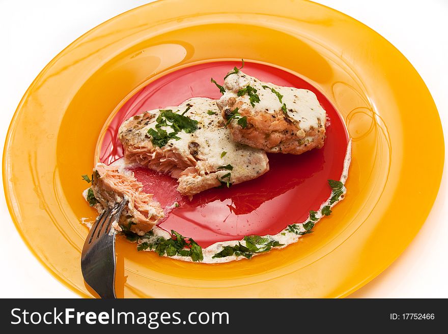 Grilled salmon with cream sauce and parsley isolated in white