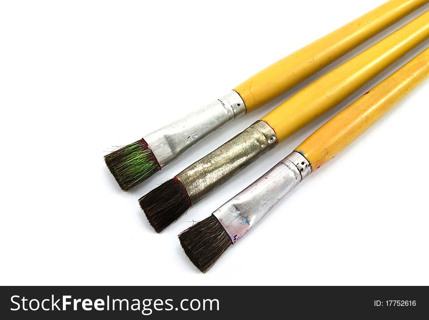 Close up of paint brushes on white background