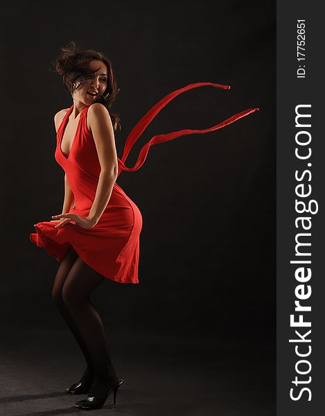 Beautiful asian girl  in red dress over black background