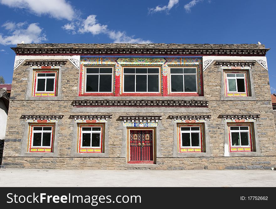 Stone house in Tibet under blue sky.