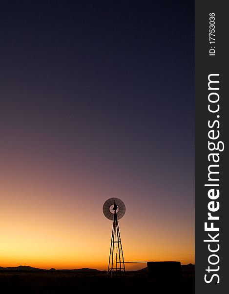 Windmill at sunset in clearing. Windmill at sunset in clearing