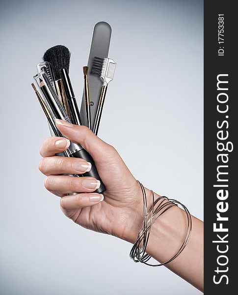 Close up on woman’s hand holding cosmetic theme objects. Close up on woman’s hand holding cosmetic theme objects