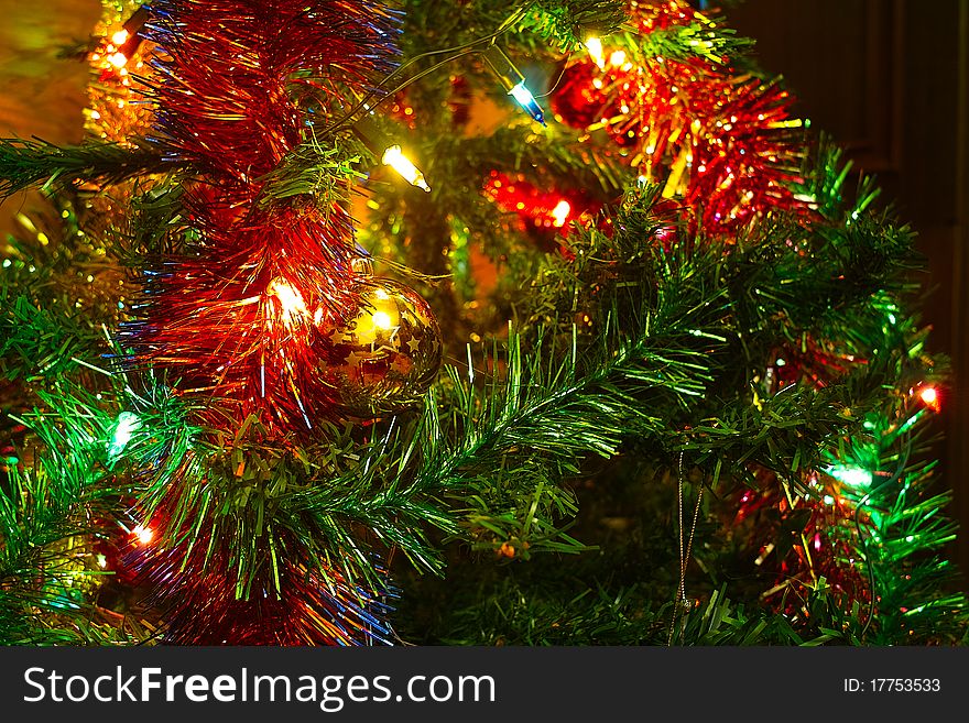 Christmas tree with a ball and garlands and lights