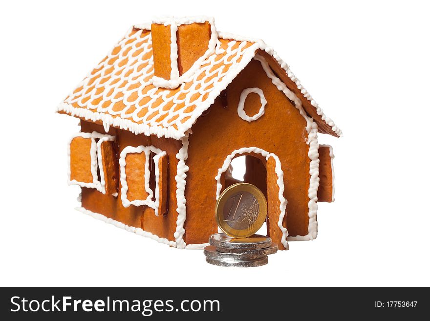 Isolated christmas gingernut house and euro coins