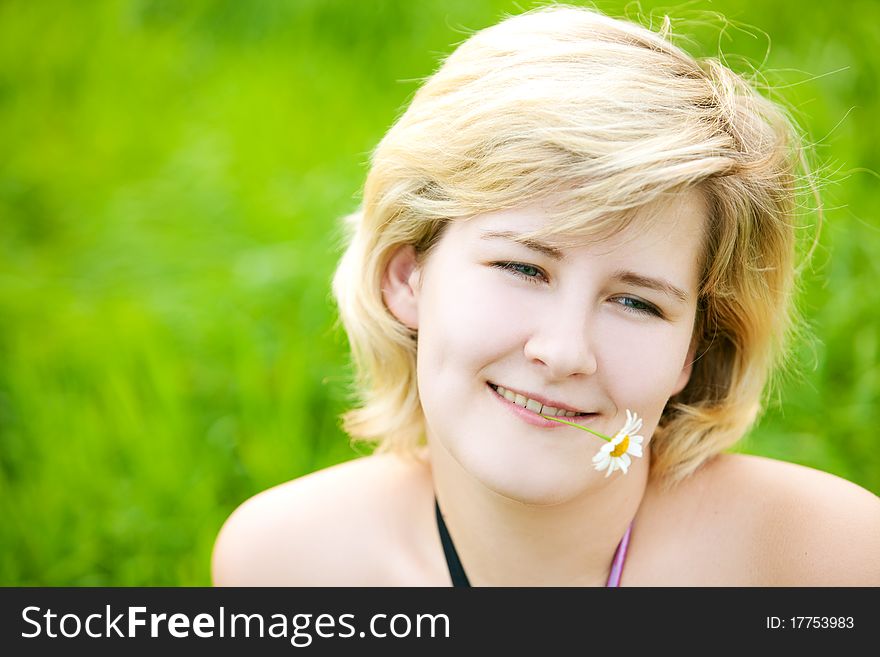 Young beautiful girl on a meadow