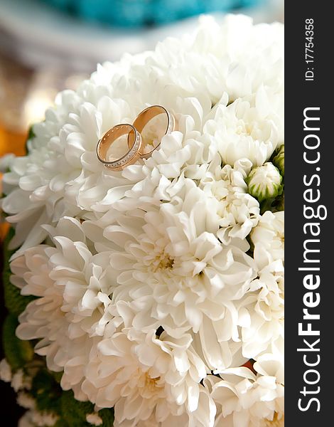 Gold bridal rings on flowers