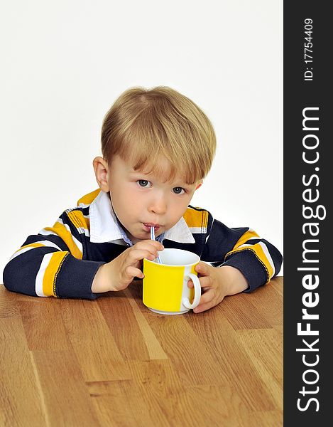 A child drinking a beverage through a straw. A child drinking a beverage through a straw