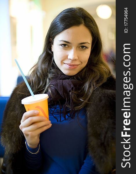 Young Girl In Fur Coat Holding A Glass Of Juice