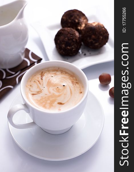 Coffee and chocolate cake on white table