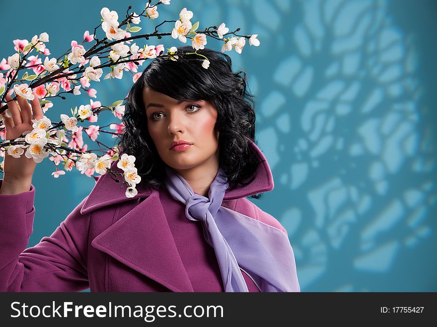 Young woman on a blue background with an apple tree. Young woman on a blue background with an apple tree