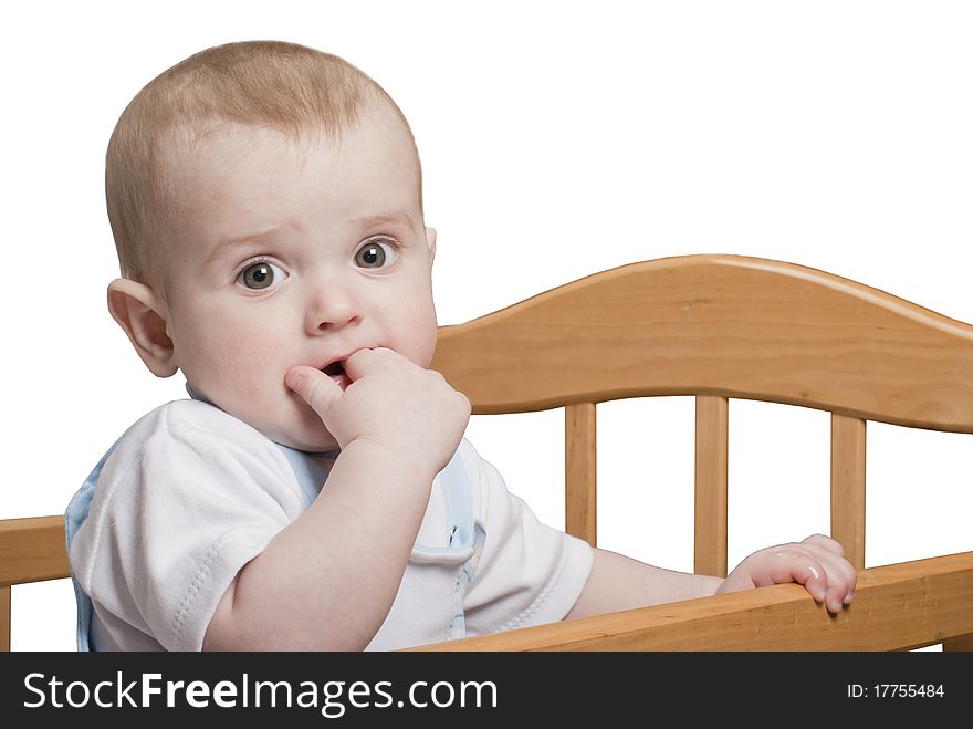 A small child standing in the crib. A small child standing in the crib