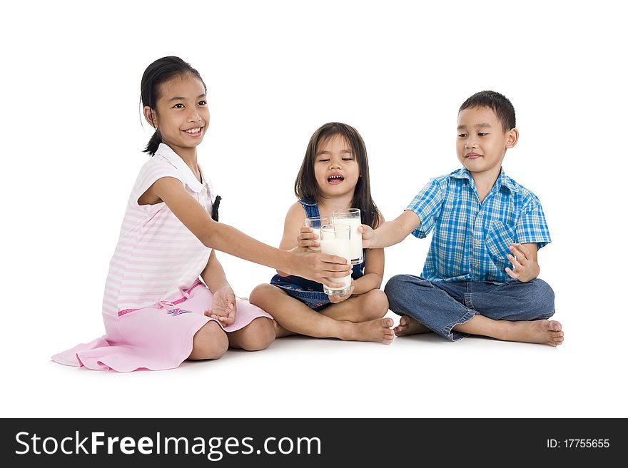 Siblings cheering with milk, isolated on white background