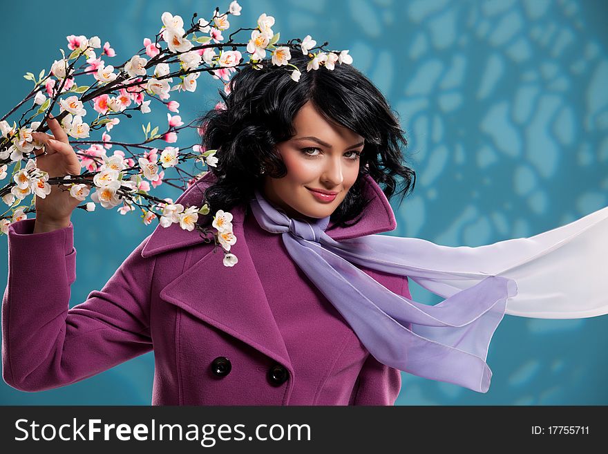 Young woman on a blue background with an apple tree. Young woman on a blue background with an apple tree