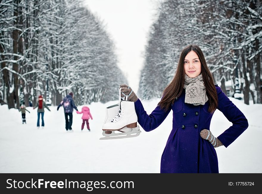 Attractive brunette young woman on the ice rink