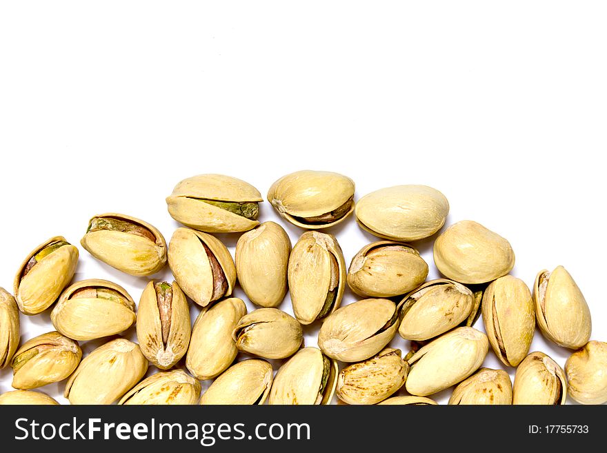 Closeup image of pistachios on white background