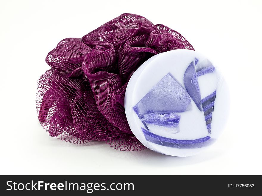 Lavender soap and purple bath sponge isolated on white