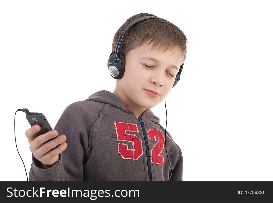 The boy in ear-phones listens to music. The boy in ear-phones listens to music