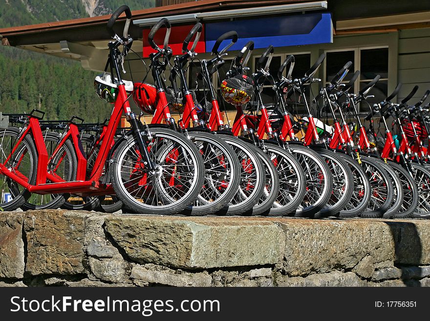 Many red downhill bicycles for rent at the swiss railway station