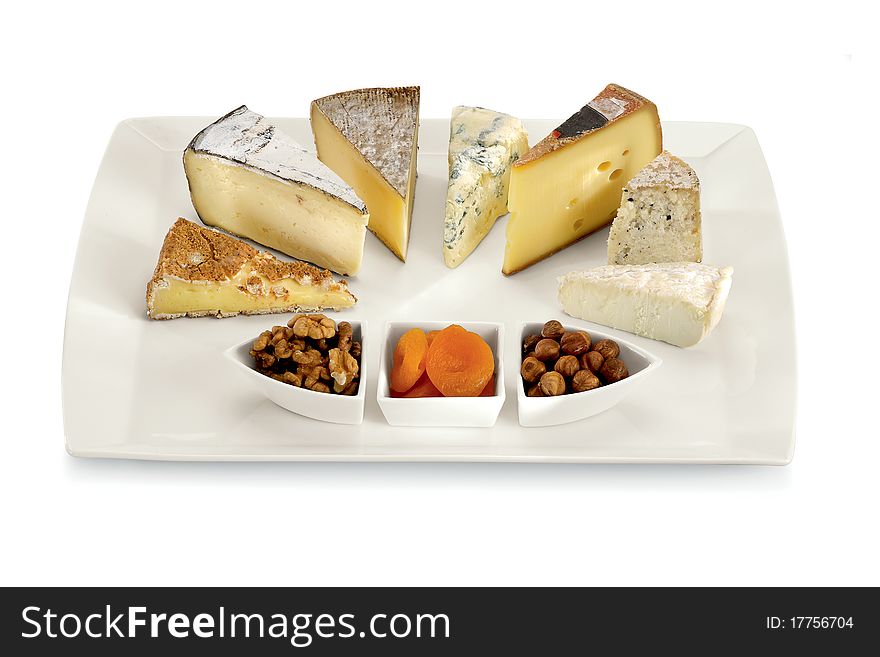 Different slice of cheese with dry fruits isolated on a white background. Different slice of cheese with dry fruits isolated on a white background.