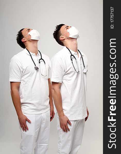 Male twin doctors posing with some medical stuff