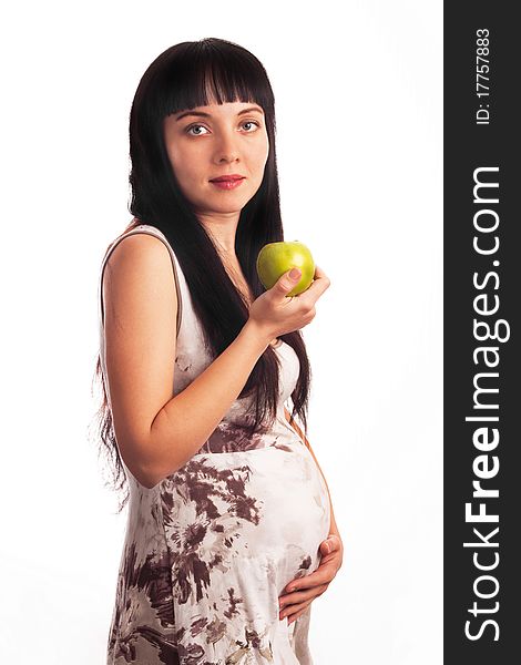 Beautiful, young pregnant girl is eating an apple. Mom, Mother, Motherhood, waiting for the child birth.