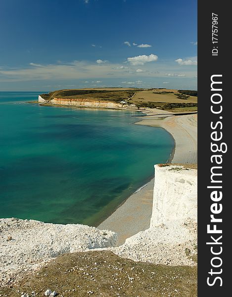 Bay at the foot of Seven Sisters, white chalk cliffs in East Sussex, United Kingdom. Bay at the foot of Seven Sisters, white chalk cliffs in East Sussex, United Kingdom.