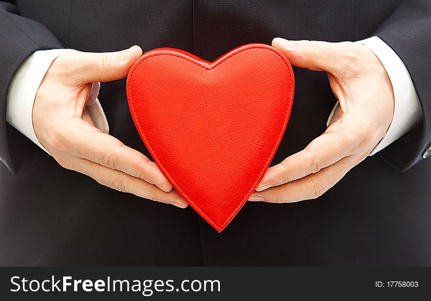 Red heart gift box in a man hand. Red heart gift box in a man hand