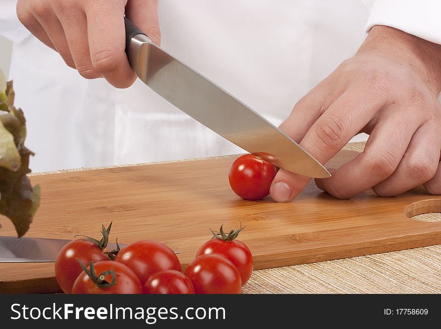 Chef Man cut vegetables on kitchen blackboard.