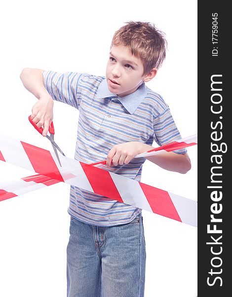 Boy with scissors behind cordon tape, isolated on white