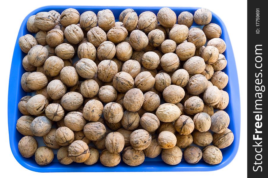 A lot of walnuts on the blue plate isolated over white. Clipping path. A lot of walnuts on the blue plate isolated over white. Clipping path.