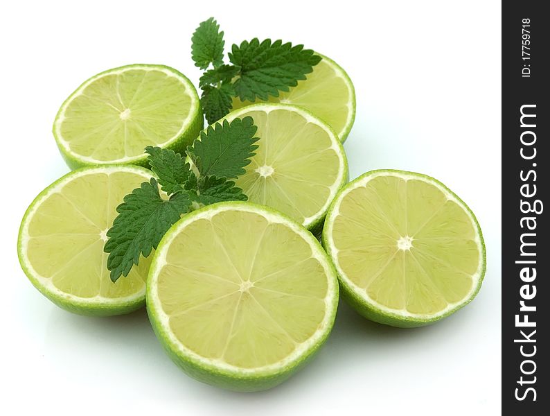 Lobes of a lime with a mint branch on a white background