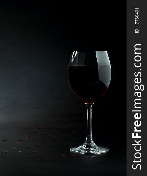 Glass of red wine on a dark background