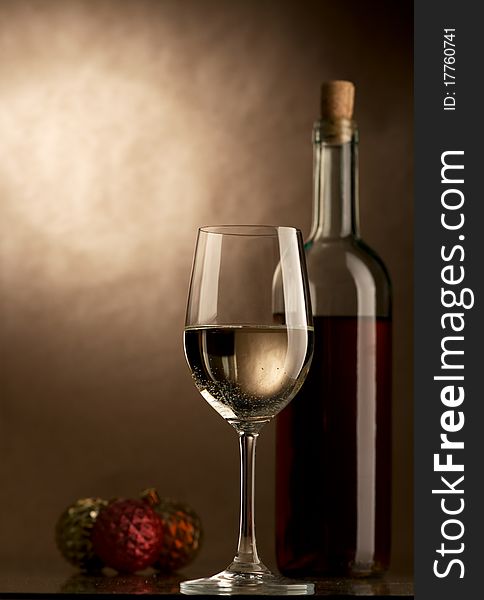 Bottle and glass of wine on a dark background