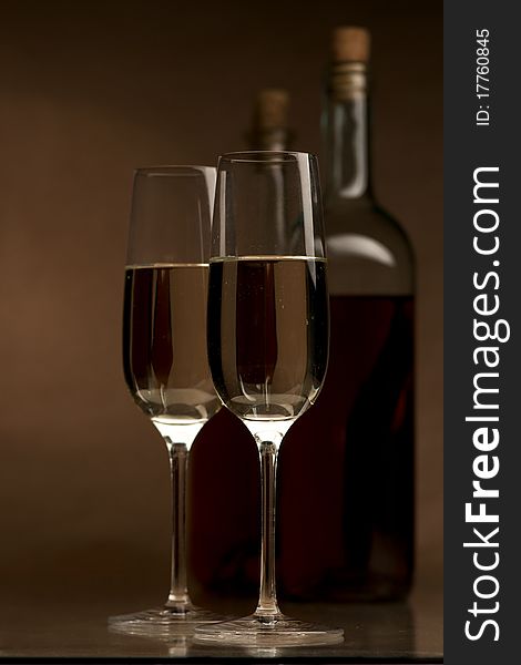 Bottle and glass of wine on a dark background