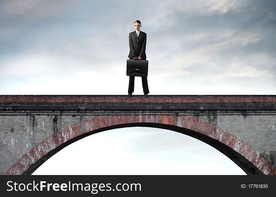 Businesswoman standing on a bridge. Businesswoman standing on a bridge