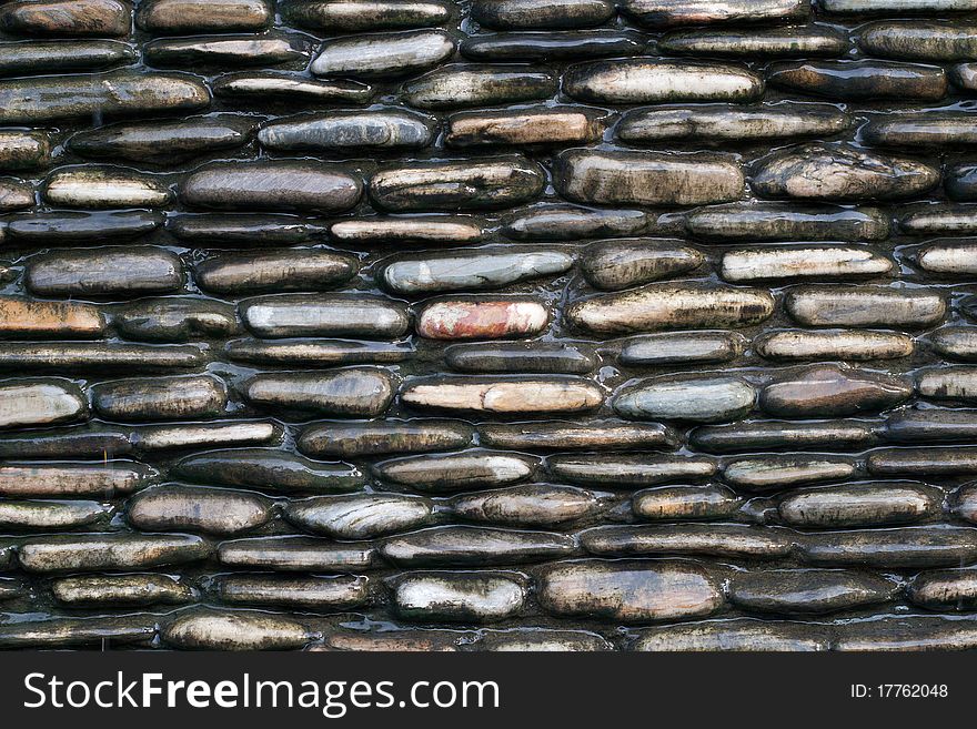 Wall of wet stones background